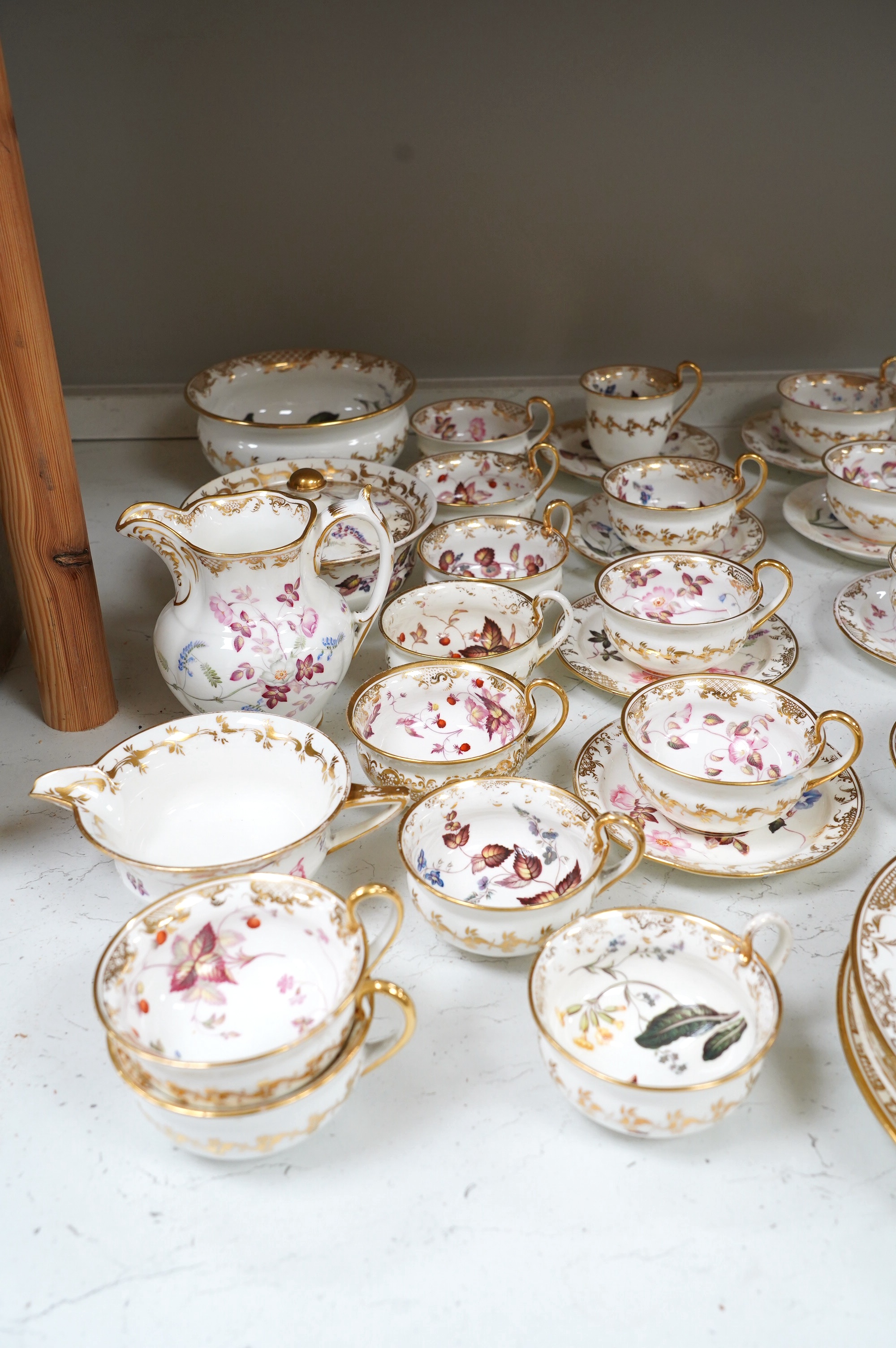 A floral part tea and coffee set, probably Swansea, c.1815-20, largest 23.5cm diameter. Condition - mostly fair